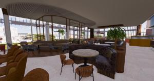 a lobby with chairs and tables in a building at Van der Valk Hotel Maastricht-Maas in Maastricht