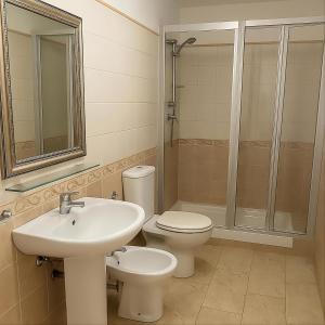 a bathroom with a sink and a toilet and a shower at Margherita Rooms in Catania +31 photos
