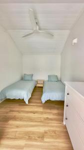 a bedroom with two beds and a ceiling at Cliff House, Azores splendid Ocean View in Horta
