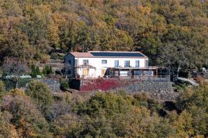 a white house in the middle of a forest at Boscoscuro in Ragalna +83 photos