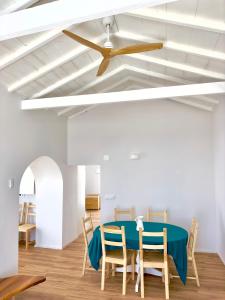 a dining room with a blue table and chairs at Cliff House, Azores splendid Ocean View in Horta