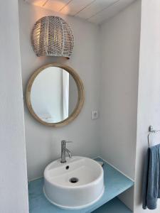 a bathroom with a white sink and a mirror at Cliff House, Azores splendid Ocean View in Horta +39 photos
