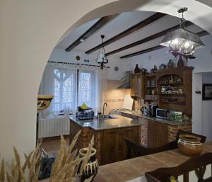 a kitchen with an archway leading to a dining room at DRUMUL DOMNISORILOR c in Buşteni