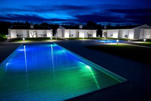 a swimming pool lit up at night at Casa da Pegada in Macedo de Cavaleiros