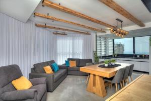a living room with two couches and a table at Open Skys in Safed