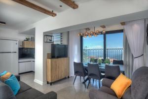 a kitchen and dining room with a table and chairs at Open Skys in Safed