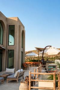 a patio with chairs and umbrellas on a building at No908 Sunset HOTEL in Çeşme +32 photos