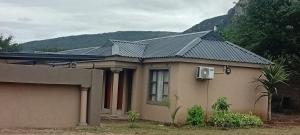 a house with a metal roof on top of it at Mkhuzewamanzi Accommodation in Mkuze