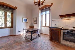 a kitchen with a table in the middle of a room at Agriturismo Le Mortinete in L'Ugolino +263 photos