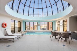 a pool in a building with a glass ceiling at Radisson Hotel Curitiba in Curitiba
