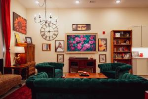 a living room with a green couch and a table at Ruby Suite - New 2 bdrm 2bath near Mass! in Lawrence