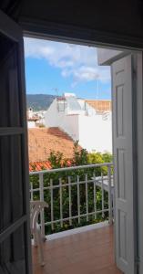 an open door to a balcony with a view at Blue Street Apartments in Pythagoreio