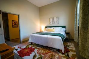 a bedroom with a bed with a flower rug at Ruby Suite - New 2 bdrm 2bath near Mass! in Lawrence