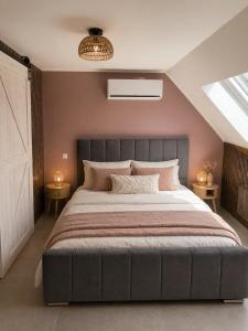 a bedroom with a large bed with two tables at Vaerthof in Diepenbeek