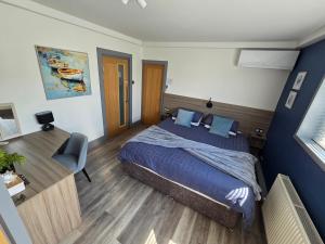 a bedroom with a king sized bed and a desk at Seabreeze The Annexe in Blackpool