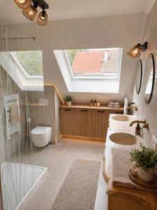 a bathroom with two sinks and a skylight at Vaerthof in Diepenbeek +24 photos