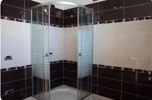 a shower with a glass door in a bathroom at Dreamy Heaven Escape Villa in Shijak +14 photos
