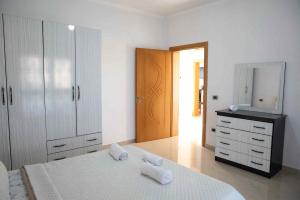 a bedroom with a bed and a dresser and a mirror at Dreamy Heaven Escape Villa in Shijak