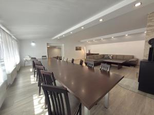 a living room with a large table and chairs at Chalupa GABO pre 15 osôb in Habovka +28 photos