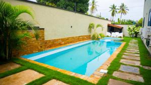 a swimming pool in front of a house at Silverado Boutique Hotel in Tanga