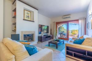 a living room with two couches and a fireplace at Casa Solea in Olbia