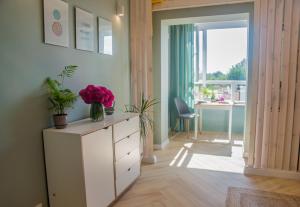 a room with a white dresser with flowers on it at Kolo in Boryspil