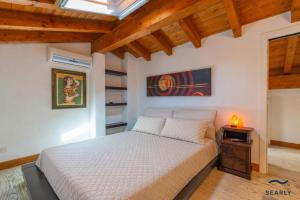 a bedroom with a bed in a room with wooden ceilings at Casa Solea in Olbia