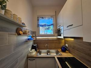 a small kitchen with a sink and a window at Galactic Sea in Comacchio