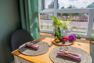 a wooden table with two straw hats and wine bottles at Kolo in Boryspil +14 photos