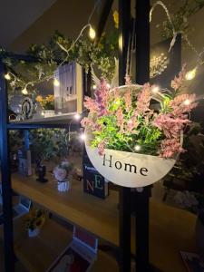 a flower pot with the words home on it at Day And Night Hotel Belmopan in Belmopan