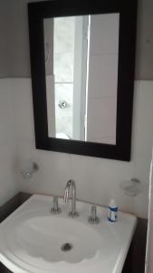 a bathroom sink with a mirror above it at Punta Gesell in Villa Gesell