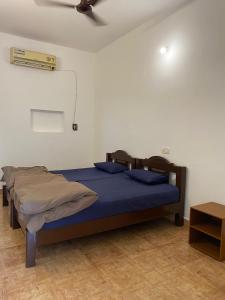 a bedroom with a bed and a ceiling fan at Anthony Stays Anjuna in Anjuna