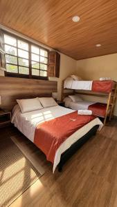 a bedroom with two beds and a window at Hotel Boutique Villa Mercedes in Sopó