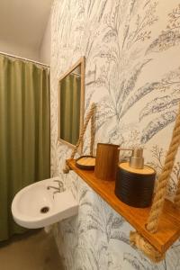 a bathroom with a sink and a mirror at Djeu Guest House in Santa Maria +54 photos