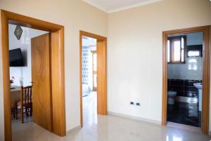 a room with a hallway with a door and a kitchen at Dreamy Heaven Escape Villa in Shijak