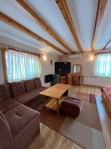 a living room with a couch and a table at Hotel Four Seasons in Samokov