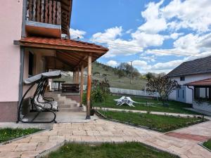 a porch of a house with a bench at Etno Kuća Jaćimović 1 in Pranjani