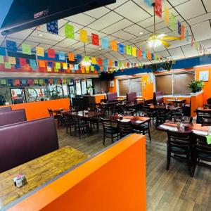 a restaurant with tables and chairs and colorful walls at Rodeway Inn Owensboro South in Owensboro