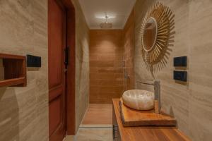 a bathroom with a sink and a mirror at M-Residence By Brassbell in Cairo +78 photos