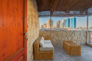 a balcony with a wicker chair and a view of the city at M-Residence By Brassbell in Cairo