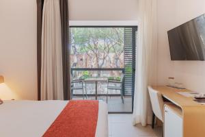 Televisor o centre d'entreteniment de NM Suites by Escampa Hotels