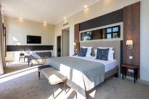a bedroom with a large bed and a living room at Westminster Hotel & Spa Nice in Nice +180 photos