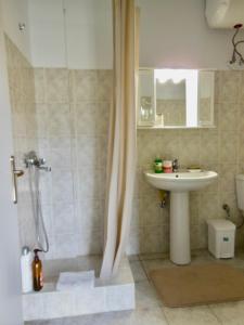 a bathroom with a sink and a shower with a sink at Quiet Mountain View Retreat Helicon, Kyriaki in Kiriákion +9 photos