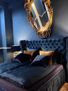 a bed in a room with a mirror on the wall at Secret Labelle Époque Hideaway in Berlin +3 photos