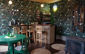 a bar with chairs and a table in a room at Villa Tornhaga in Oskarström