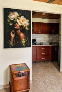 a painting of a woman talking on a cell phone in a kitchen at Salento verde in Salento