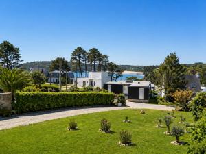 a view of a garden with trees and houses at La Maison des Écumes in Crozon