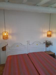 a bedroom with a large white bed with two lights at Olive -Casa da Boavista in Alegrete +21 photos