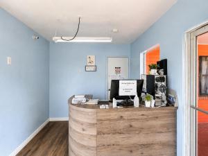 a counter in a room with a blue wall at Stevens Motel by Capital O Ocala US 27 in Ocala