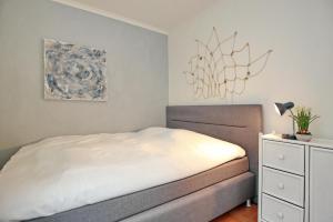 a bedroom with a bed and a chandelier at Dünenschloss Wohnung 2-11 in Kühlungsborn +22 photos